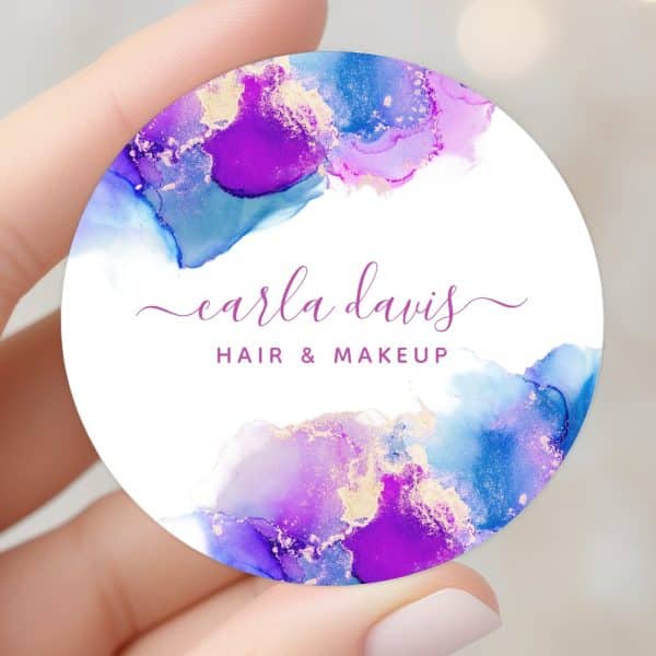 Round Business Card Featuring Purple And Blue Watercolor Design With Gold Accents, Displaying Carla Davis Hair &Amp; Makeup.
