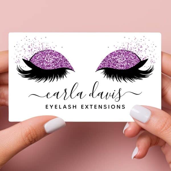 Business Card Featuring A Pair Of Eyes With Purple Glitter Eyeshadow And Long Lashes; Carla Davis Eyelash Extensions.
