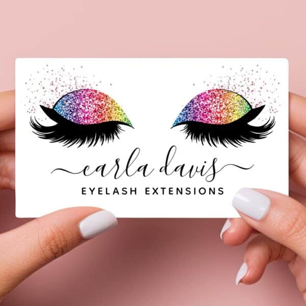A Business Card Featuring Rainbow Glitter Eyelashes And The Text Carla Davis Eyelash Extensions.
