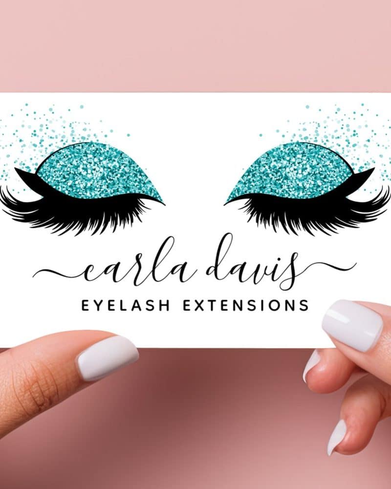 A business card for Carla Davis Eyelash Extensions featuring a pair of eyes with teal glitter eyeshadow and long lashes.