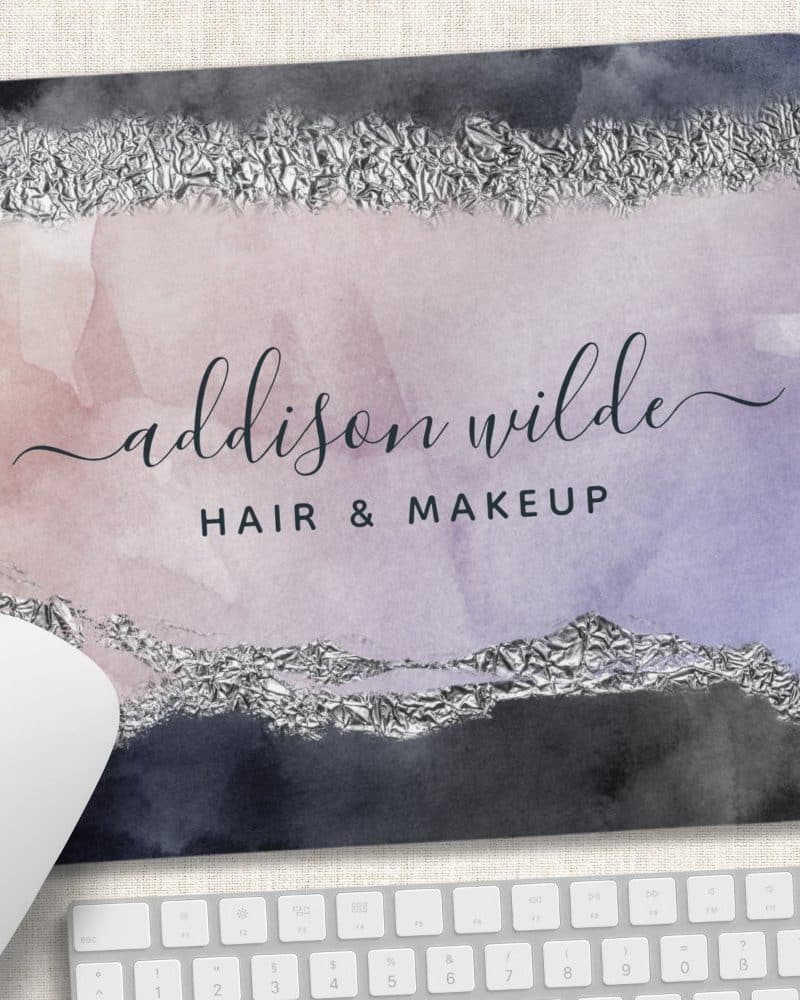 Mousepad with watercolor design in shades of purple and gray, accented with silver foil, displaying the name Addison Wilde Hair & Makeup.