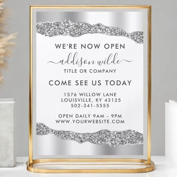 Gold-Framed Sign Announcing Addison Wilde'S Grand Opening, Including Address, Phone Number, And Website.