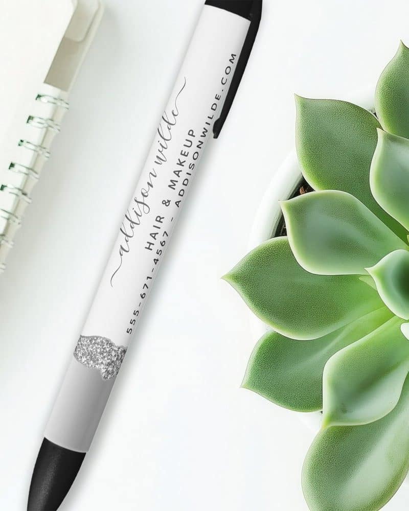 White pen with black ink and Addison Wilde's hair and makeup business information.