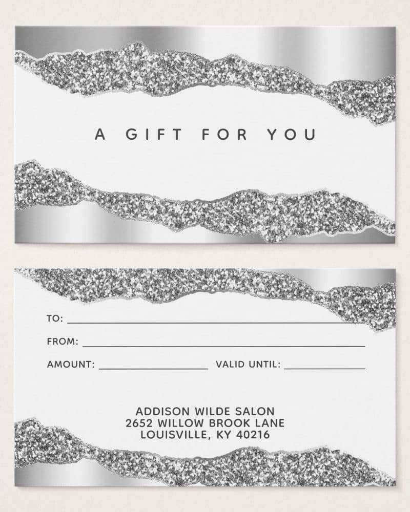 Silver glitter gift certificate with space to fill in recipient, sender, amount, and expiration date. The salon's name and address are included at the bottom.