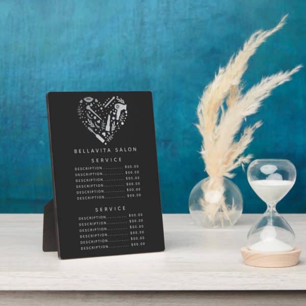 Black Salon Price List Sign With A Silver Heart-Shaped Logo Of Beauty Tools.