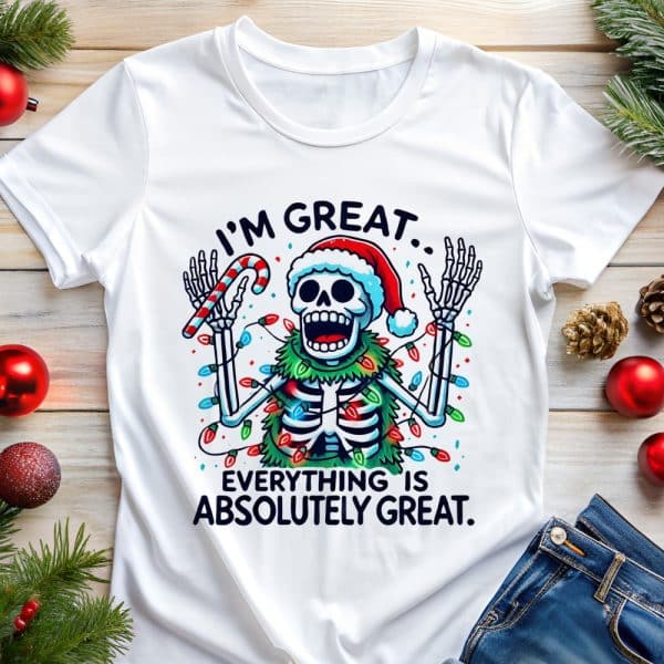 White T-Shirt Featuring A Skeleton Wearing A Santa Hat And Christmas Lights, Holding A Candy Cane; Text Reads Im Great. Everything Is Absolutely Great.