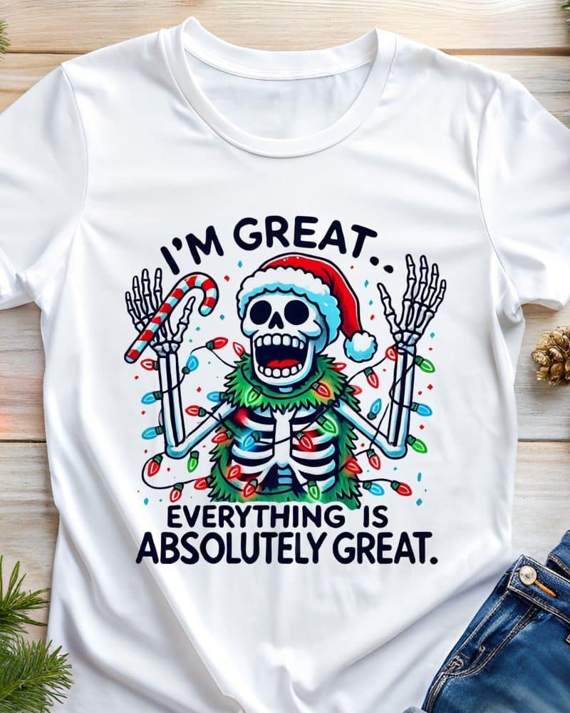 White t-shirt featuring a skeleton wearing a Santa hat and Christmas lights, holding a candy cane; text reads Im great. Everything is absolutely great.