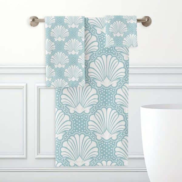 Light Blue Bath Towels With A White Seashell Pattern.
