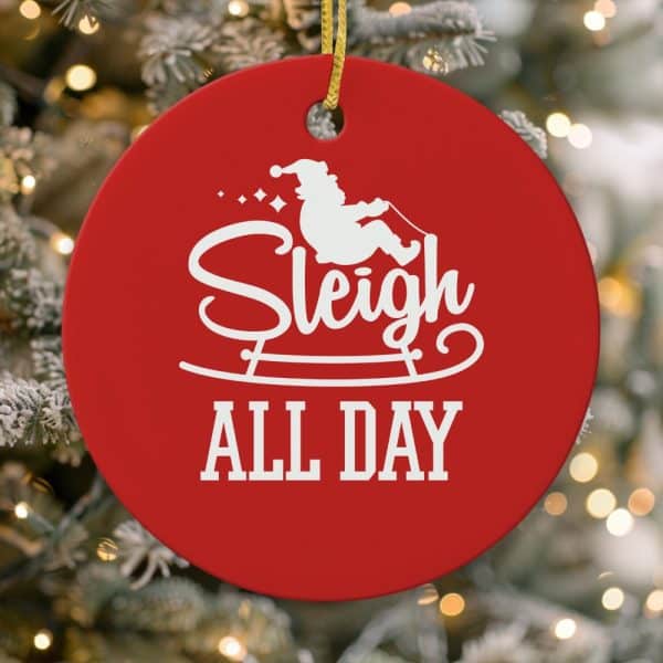Red Round Christmas Ornament With A White Silhouette Of Santa In A Sleigh And The Text Sleigh All Day.