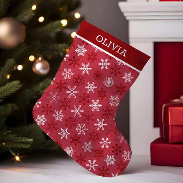 Red Christmas Stocking With A White Snowflake Pattern And The Name Olivia.
