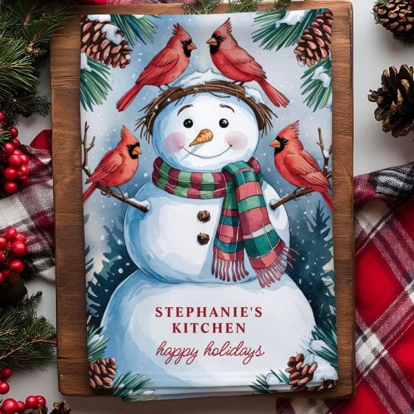 A Watercolor Illustration Of A Snowman Wearing A Scarf, Surrounded By Four Cardinals, With The Text Stephanie'S Kitchen Happy Holidays.