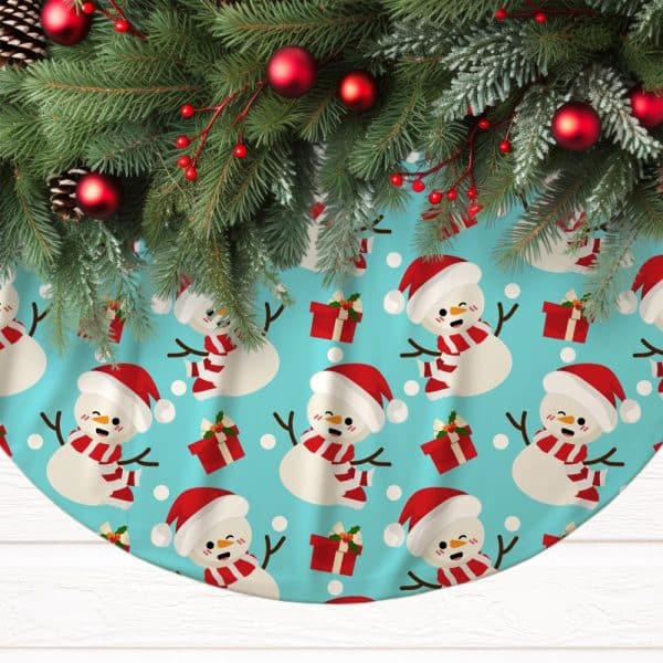 Christmas Tree Skirt With A Teal Background And A Repeating Pattern Of Smiling Snowmen Wearing Santa Hats And Scarves, Next To Red Presents.