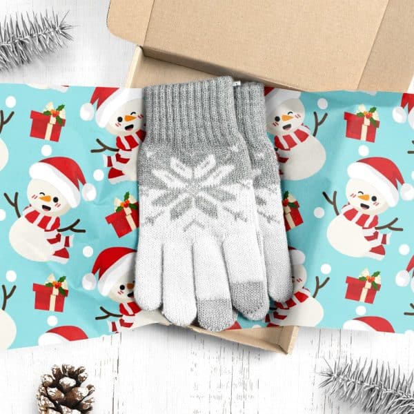 Pair Of Gray And White Knit Gloves With Snowflake Pattern In A Christmas-Themed Gift Box.