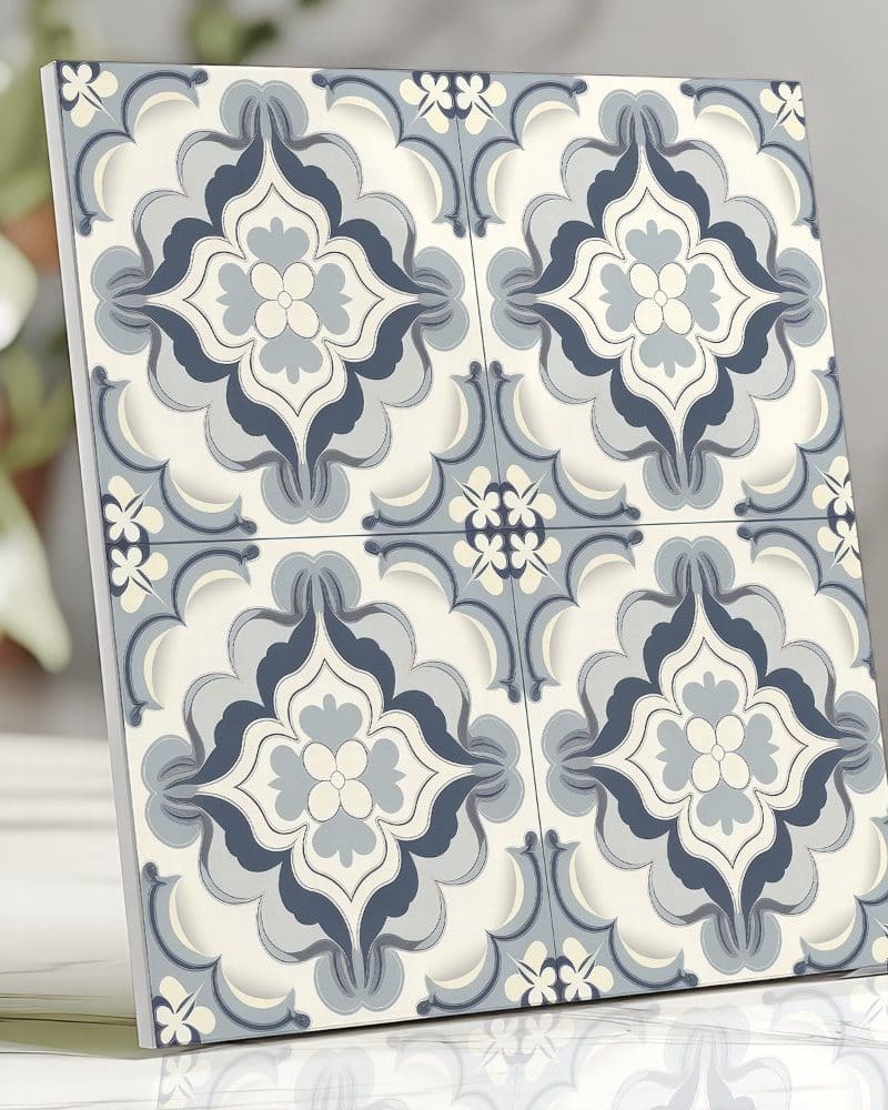 A square tile with a repeating blue and off-white floral pattern.