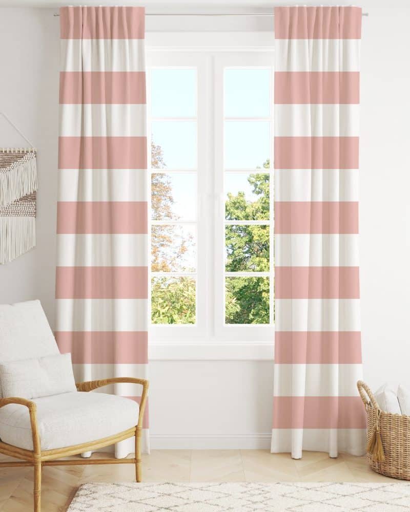 Pink and white striped curtains hang in front of a window.