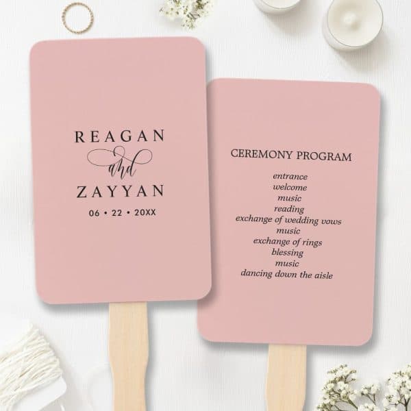 Two Blush Pink Wedding Ceremony Programs Shaped Like Hand Fans; One Lists The Couple'S Names And Wedding Date, The Other Details The Ceremony Events.