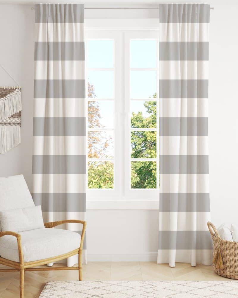 Gray and white striped curtains hang on a window.