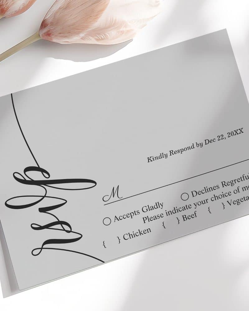 A gray wedding RSVP card with a black script design and meal options.