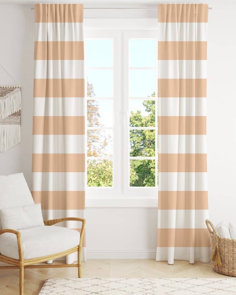 Peach and white striped curtains hang in front of a window.