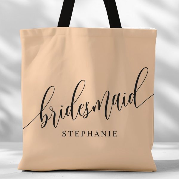 Beige Tote Bag With Black Script Text Reading Bridesmaid Stephanie.