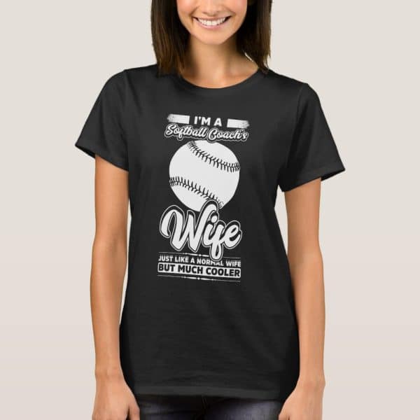 Woman Wearing A Black T-Shirt That Says Im A Softball Coach'S Wife, With A Softball Graphic And The Words Just Like A Normal Wife But Much Cooler.