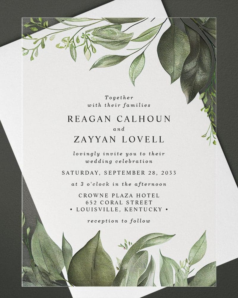 Wedding invitation with greenery border, announcing the marriage of Reagan Calhoun and Zayyan Lovell.