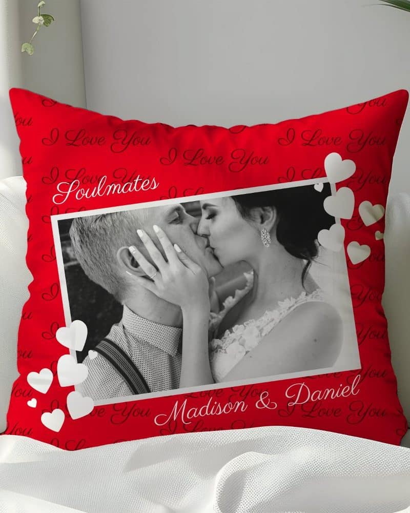 Red pillow with a black and white photo of a kissing couple and the words I Love You, Soulmates, Madison & Daniel.