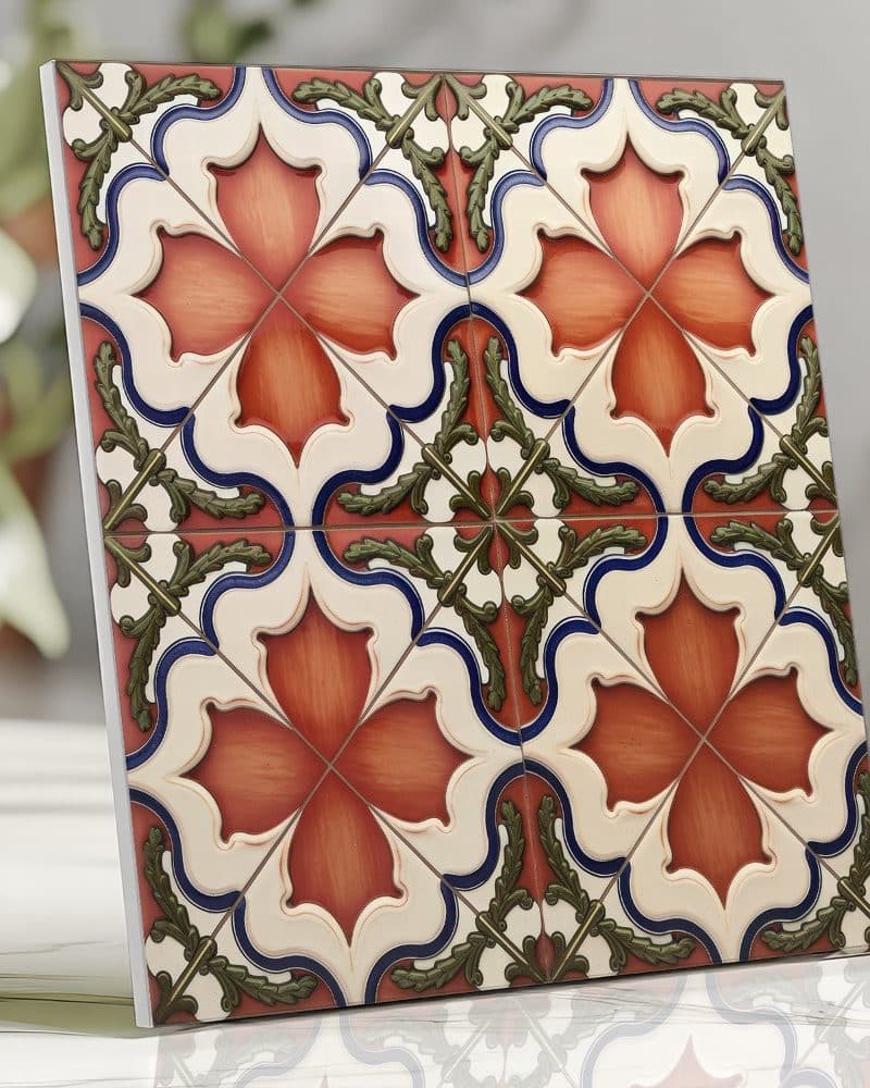 Ornate square tile with a repeating pattern of reddish-orange flowers and green-blue foliage on a cream background.