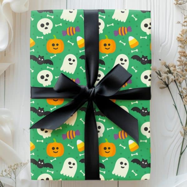Halloween Gift Wrapped In Green Paper With A Black Ribbon. The Wrapping Paper Features Ghosts, Pumpkins, Candy Corn, And Skulls.