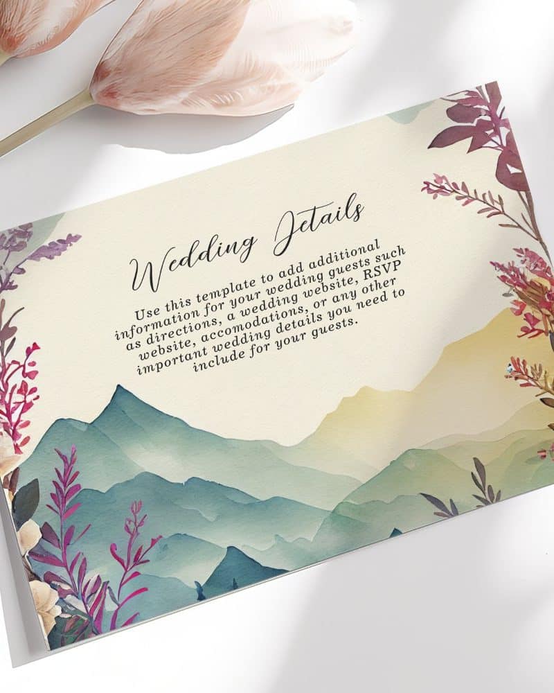 Wedding details card with watercolor mountain range and floral design.