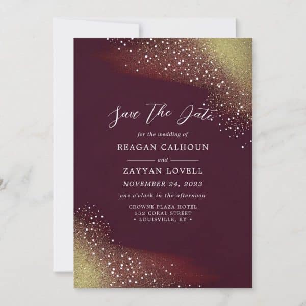 Burgundy Save The Date Card With Gold Glitter Detailing, Announcing The Wedding Of Reagan Calhoun And Zayyan Lovell On November 24, 2023.