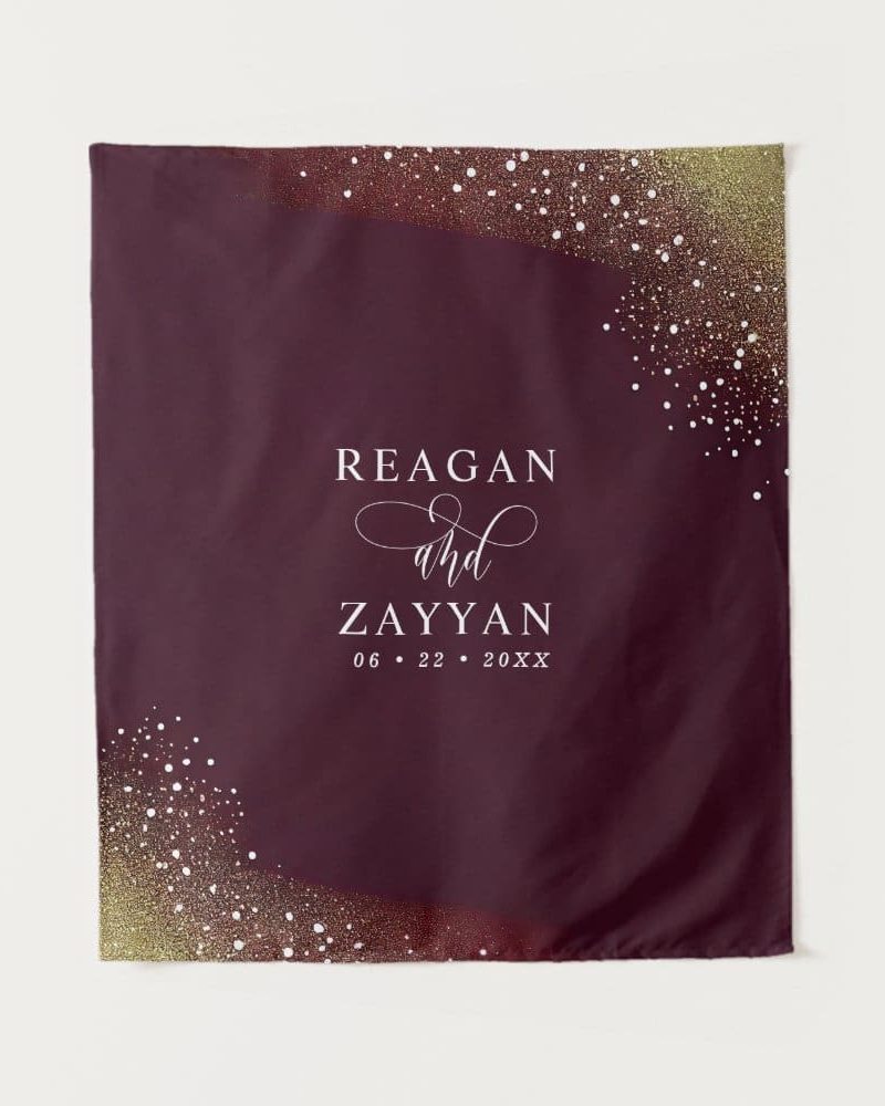 Burgundy wedding banner with gold confetti and the names Reagan and Zayyan and wedding date.