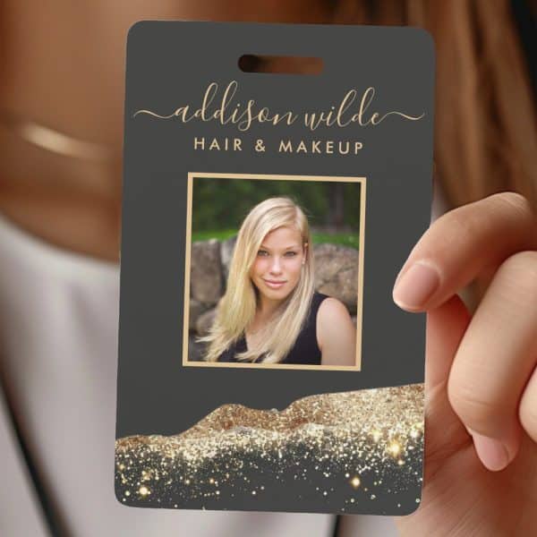 Dark Gray Name Tag With Gold Lettering For Addison Wilde Hair &Amp; Makeup, Featuring A Photo Of A Blonde Woman And A Gold Glitter Design At The Bottom.
