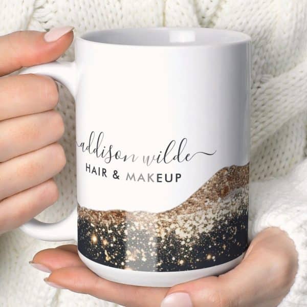 A White Coffee Mug With The Name Addison Wilde Hair &Amp; Makeup And A Sparkly Gold And Black Design.