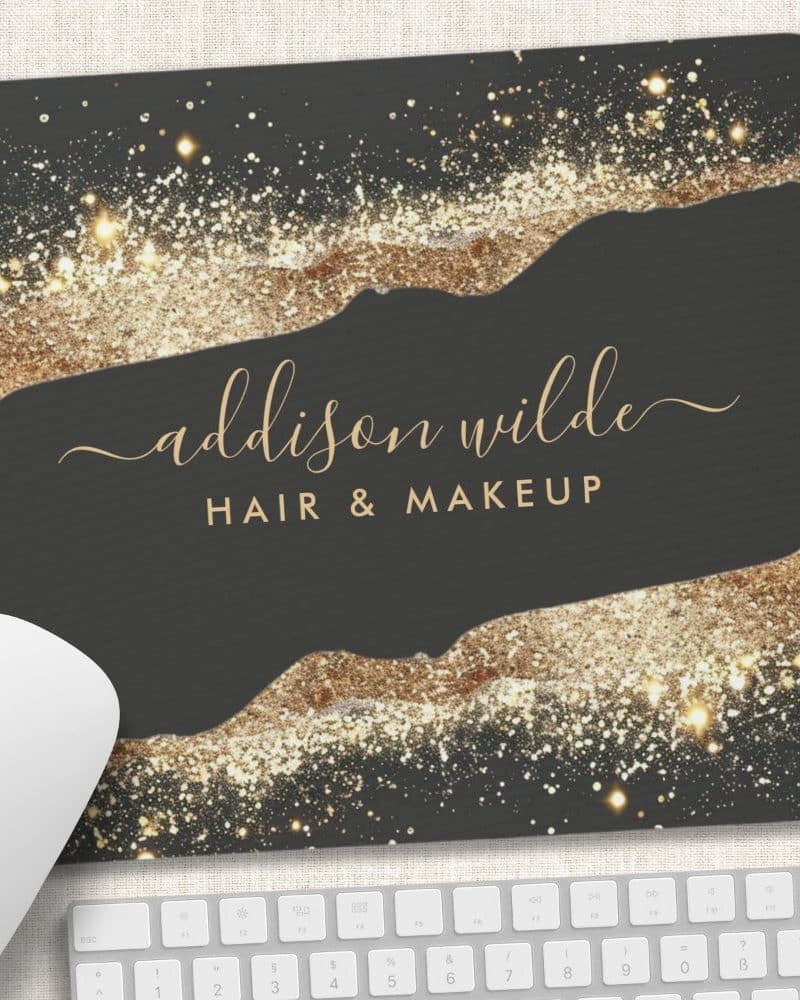 Dark gray mousepad with gold glitter detailing and the name Addison Wilde Hair & Makeup in elegant script.