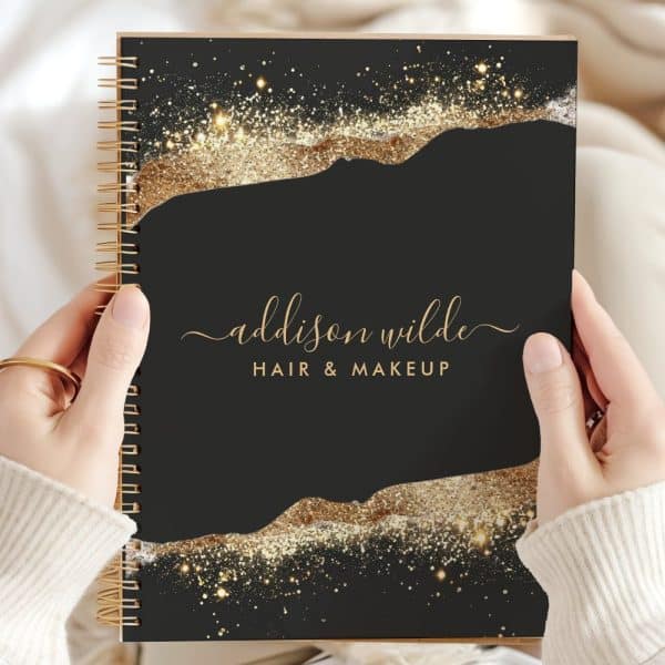 Black Spiral Notebook With Gold Glitter Design And Addison Wilde Hair &Amp; Makeup In Gold Lettering.
