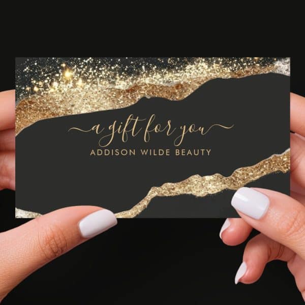 A Black Gift Card With Gold Glitter Accents, Reading A Gift For You And Addison Wilde Beauty.