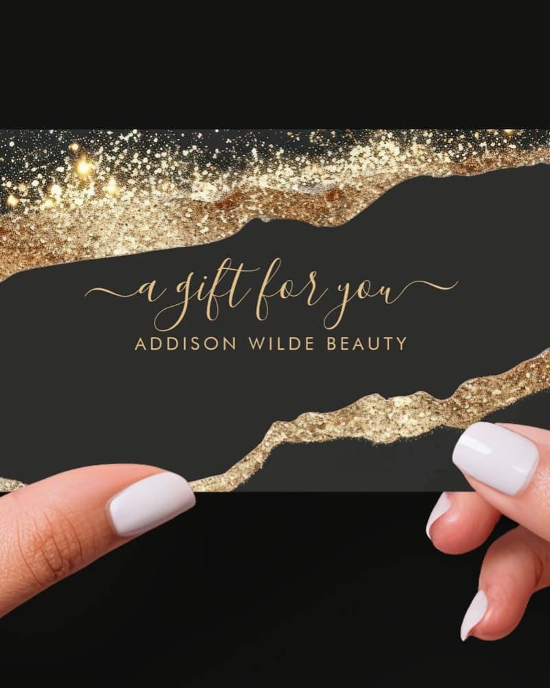 A black gift card with gold glitter accents, reading A gift for you and Addison Wilde Beauty.