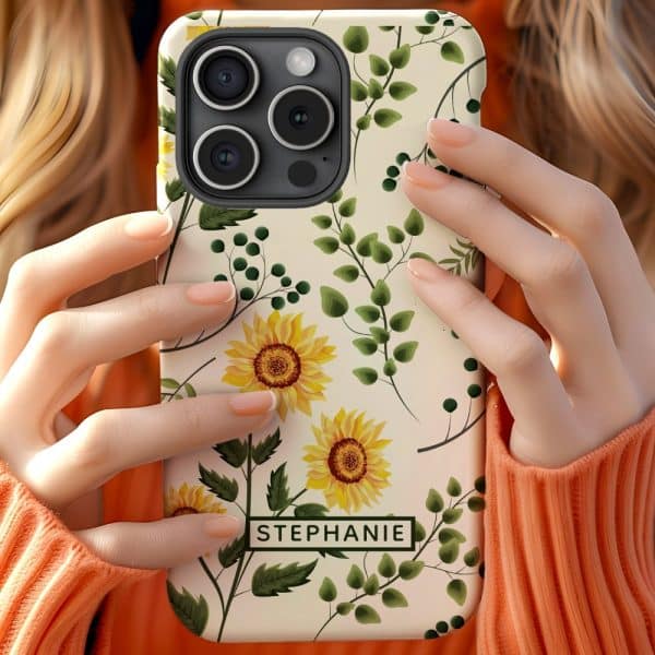 Close-Up Of Hands Holding A Phone Case With A Sunflower And Greenery Design, The Name Stephanie Is Visible On The Case.