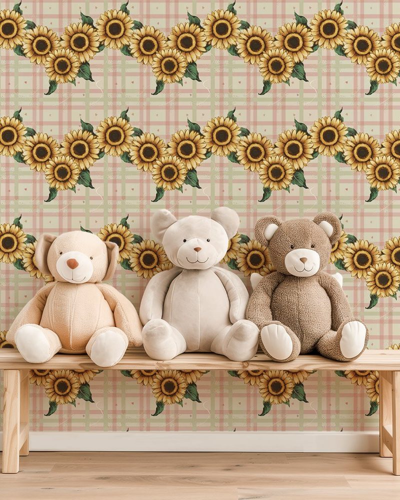 Three teddy bears sit on a wooden bench in front of a wall featuring a repeating pattern of sunflowers on a pale pink and green plaid background.