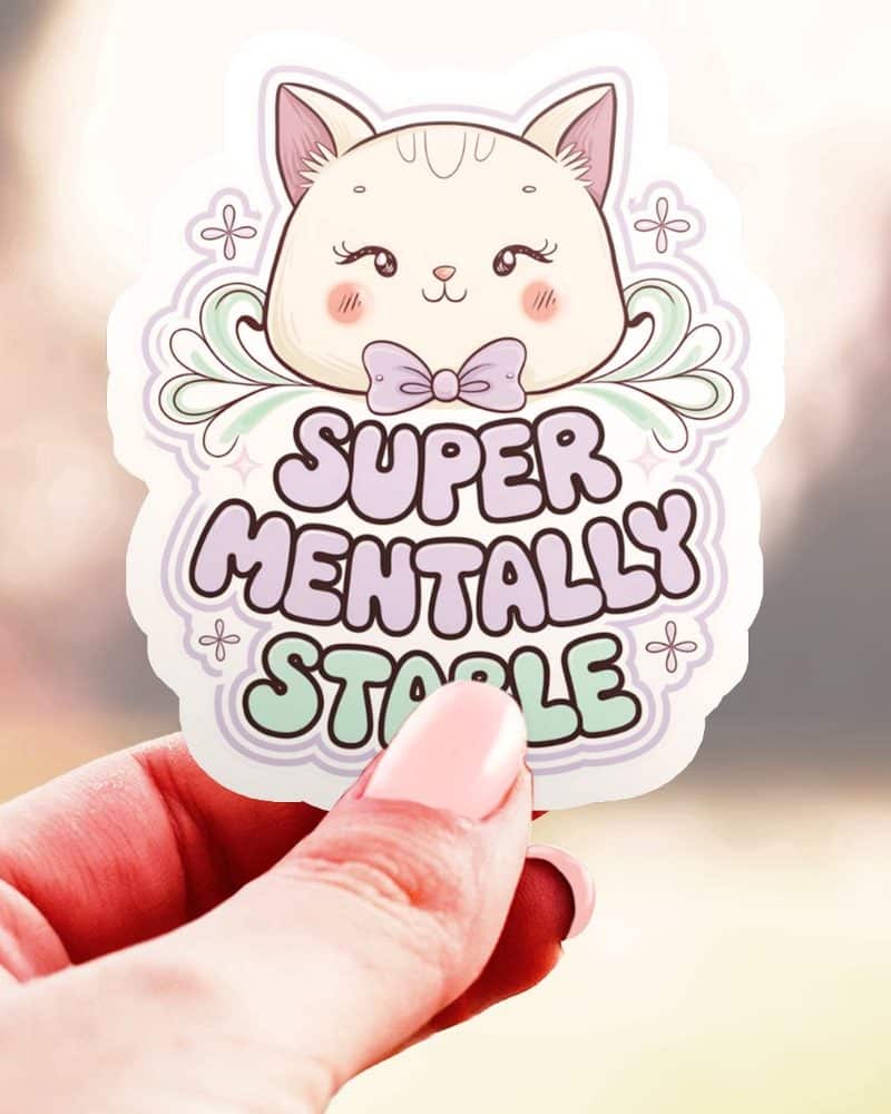 Hand holding a sticker featuring a cute cartoon cat wearing a bow and the text Super Mentally Stable.