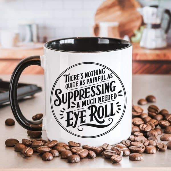 White Coffee Mug With Black Handle And Interior, Displaying A Circular Design With Text That Reads, Theres Nothing Quite As Painful As Suppressing A Much Needed Eye Roll.