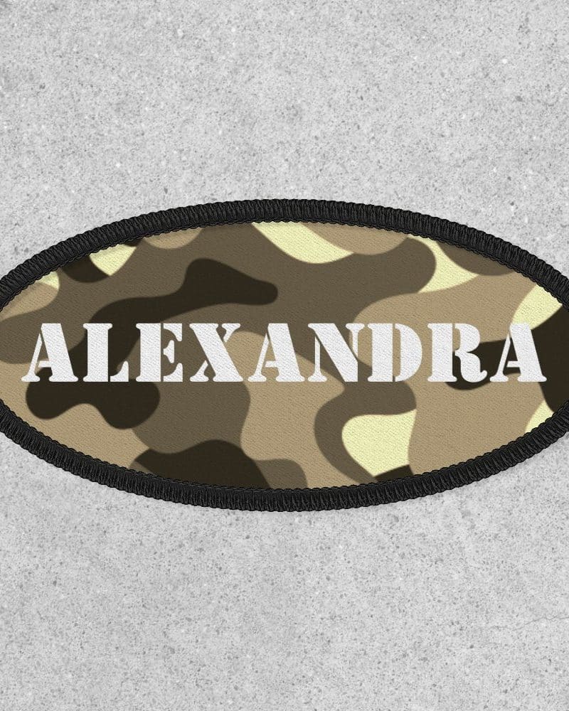 Oval camouflage patch with the name Alexandra in white lettering.