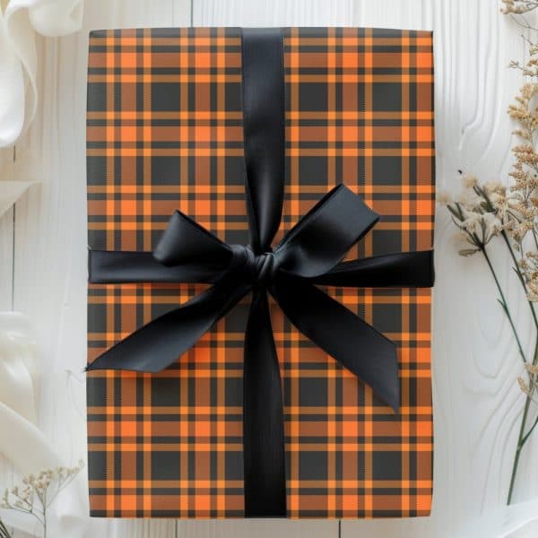 A Gift Wrapped In Black And Orange Plaid Paper With A Black Ribbon.