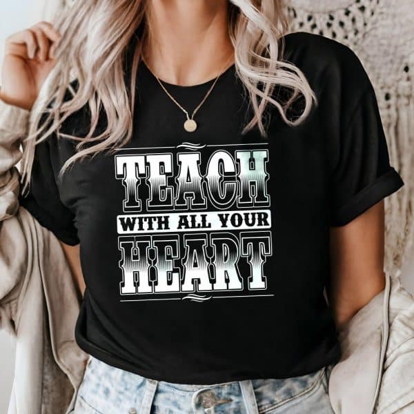 Woman Wearing A Black T-Shirt That Says Teach With All Your Heart In A Western-Style Font.