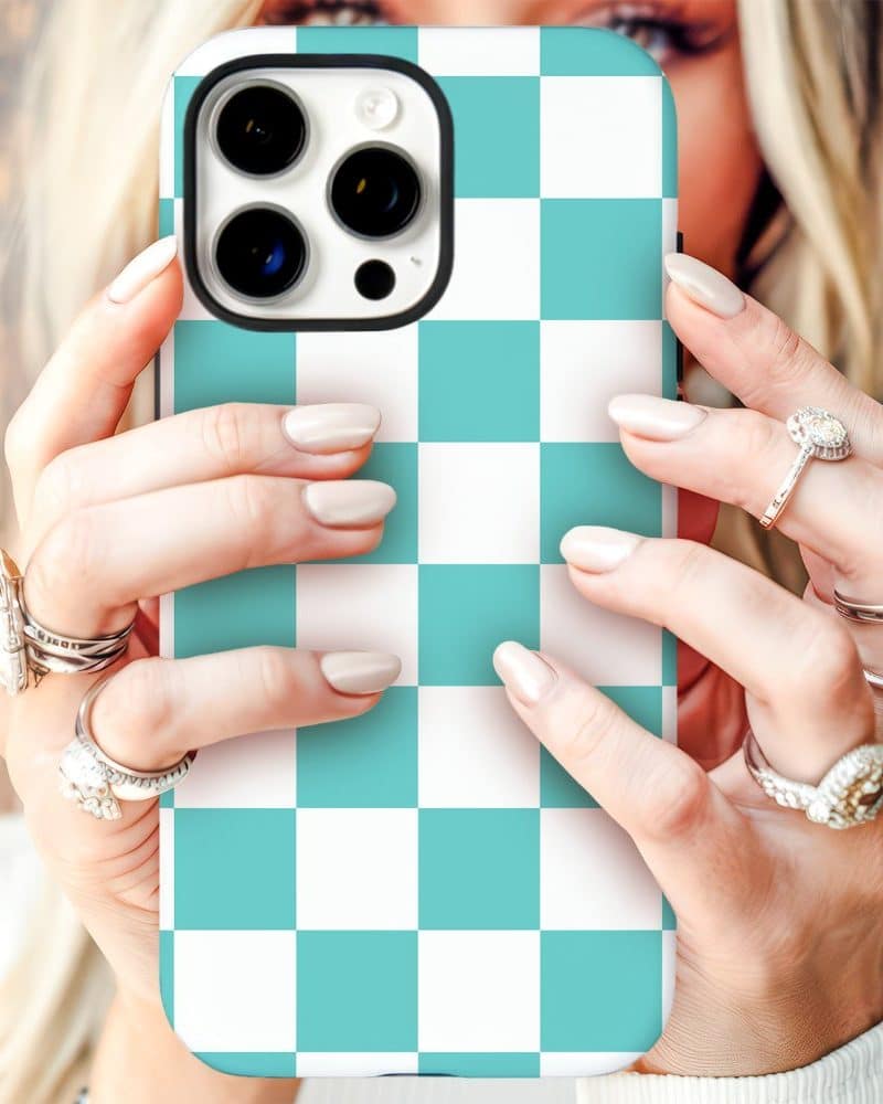 Woman's hands holding a teal and white checkered iPhone case.