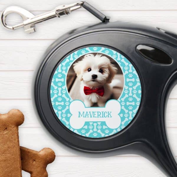 Retractable Dog Leash With A Personalized Photo Of A Small White Dog Wearing A Red Bow Tie. The Dogs Name, Maverick, Is Printed On The Leash.