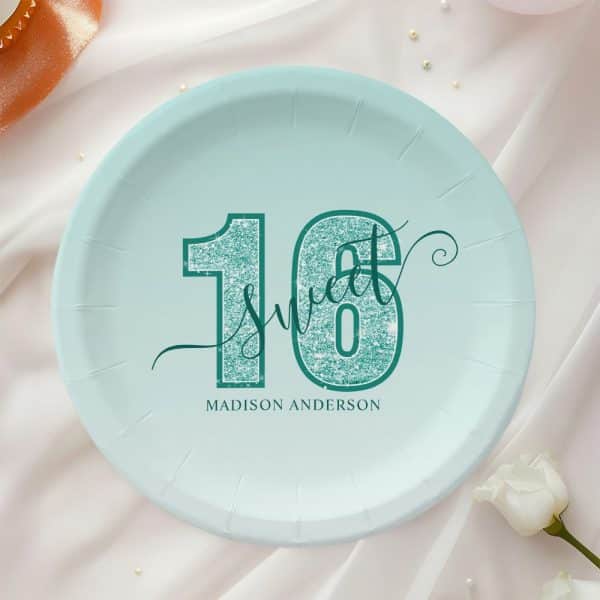 A Teal And Light Blue Paper Plate With The Number Sixteen, The Words Sweet Sixteen, And The Name Madison Anderson.
