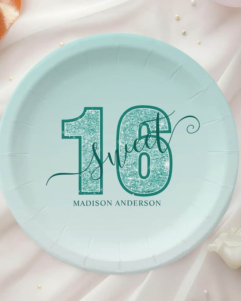 A teal and light blue paper plate with the number sixteen, the words Sweet Sixteen, and the name Madison Anderson.