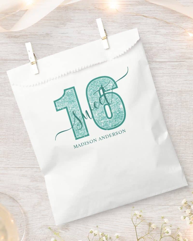 White party favor bag with teal glitter Sweet 16 design and Madison Anderson's name.